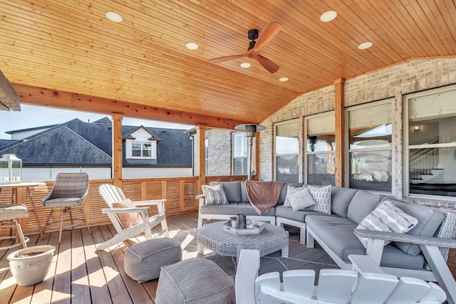 sunroom / solarium with vaulted ceiling, wood ceiling, and ceiling fan