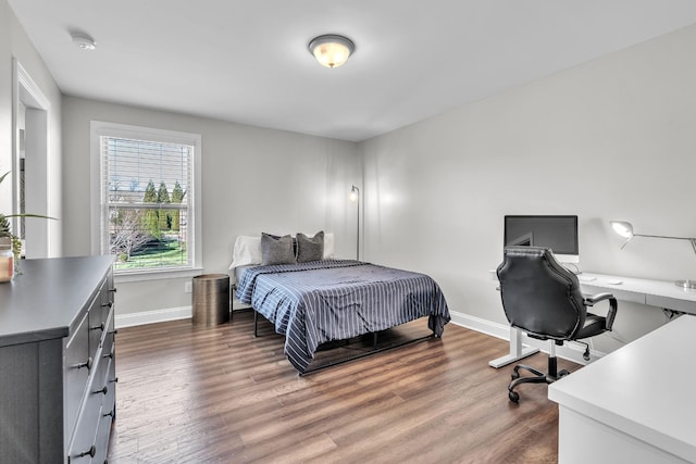 bedroom with wood finished floors and baseboards