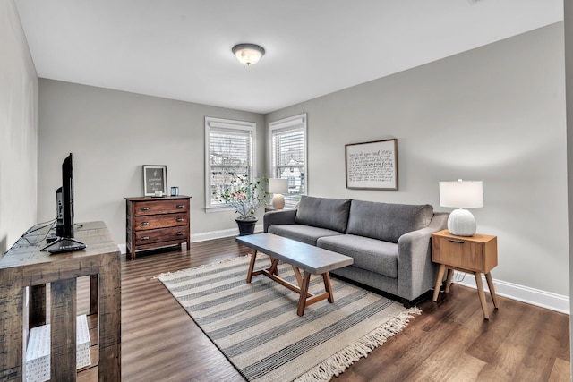 living room featuring dark wood-type flooring and baseboards