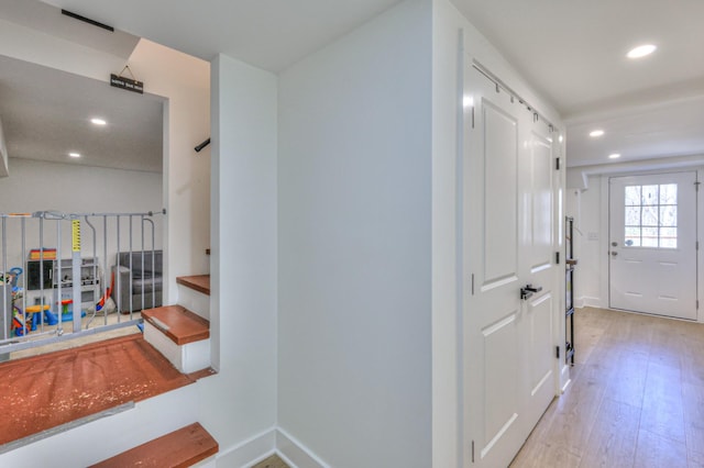 hall with recessed lighting, stairway, baseboards, and wood finished floors