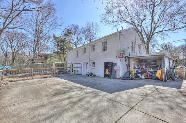 rear view of property featuring fence