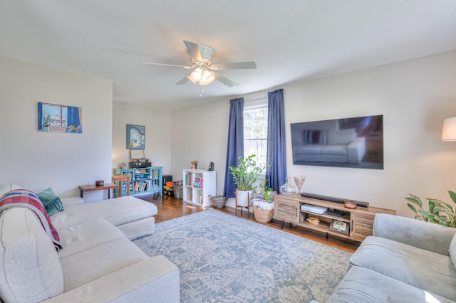 living room with a ceiling fan and wood finished floors