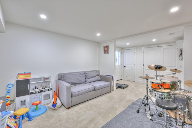 game room with a wall mounted air conditioner, recessed lighting, and carpet floors