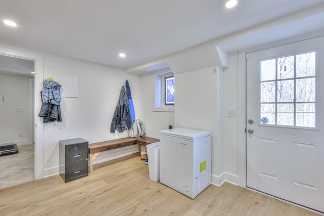 clothes washing area featuring a wealth of natural light, recessed lighting, and light wood-style floors