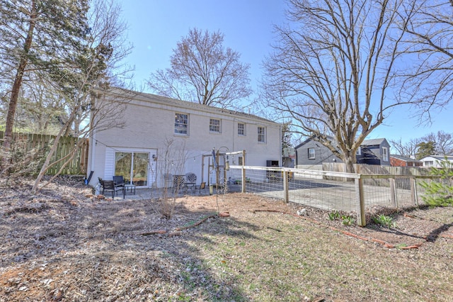 rear view of house featuring a patio area and fence private yard