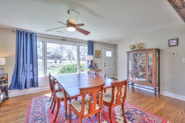 dining area featuring visible vents, ceiling fan, light wood-type flooring, and baseboards