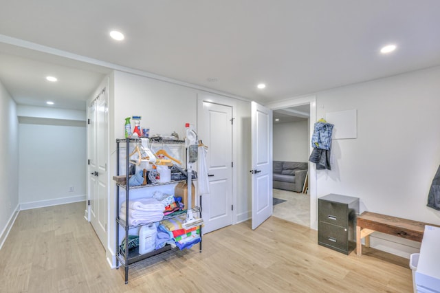 hall with recessed lighting, baseboards, and light wood finished floors