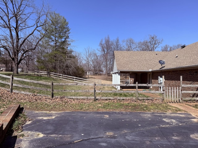 exterior space featuring a rural view and fence