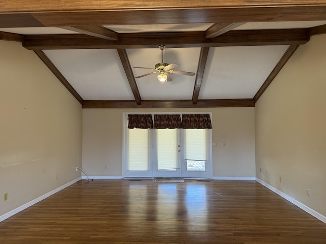 spare room with lofted ceiling with beams, wood finished floors, baseboards, and ceiling fan