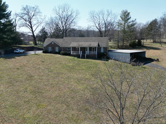 view of front of home with a porch and a front yard