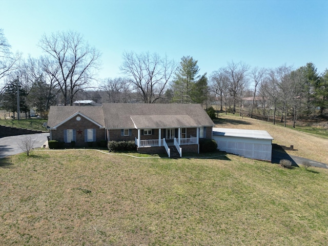 ranch-style house featuring a porch and a front yard