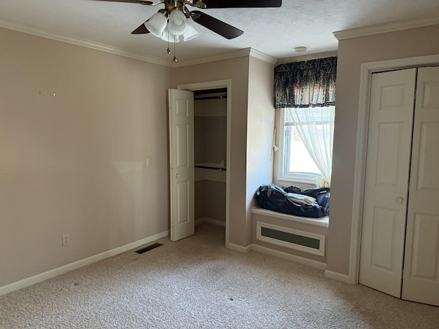 unfurnished bedroom featuring crown molding, light colored carpet, visible vents, and baseboards