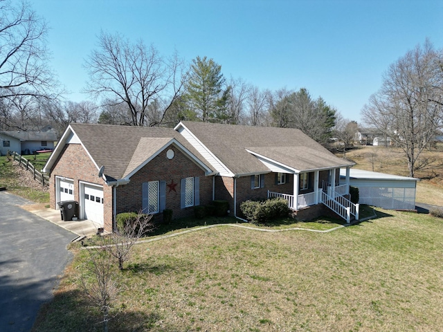 ranch-style house with aphalt driveway, brick siding, a porch, and a front yard