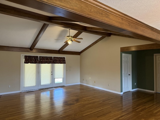 empty room with baseboards, vaulted ceiling with beams, a ceiling fan, and wood finished floors