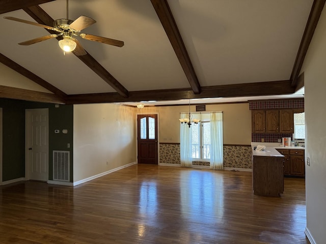 unfurnished living room with visible vents, vaulted ceiling with beams, dark wood-style flooring, and ceiling fan with notable chandelier