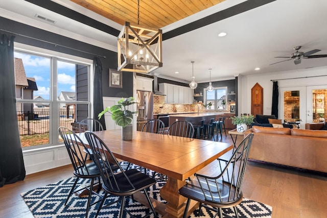 dining space featuring a wealth of natural light, visible vents, and wood finished floors