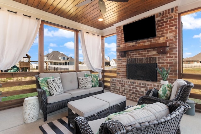 view of patio featuring an outdoor living space with a fireplace, ceiling fan, and fence