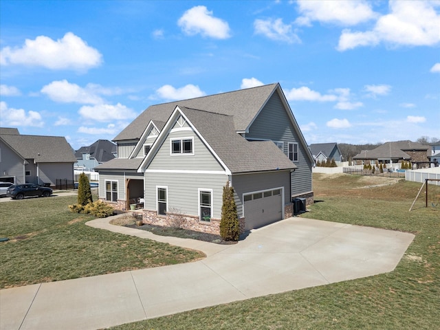 view of property exterior featuring driveway, a shingled roof, stone siding, a lawn, and a residential view