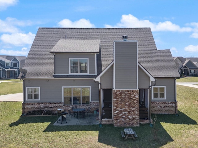 back of property featuring a lawn, brick siding, and a chimney