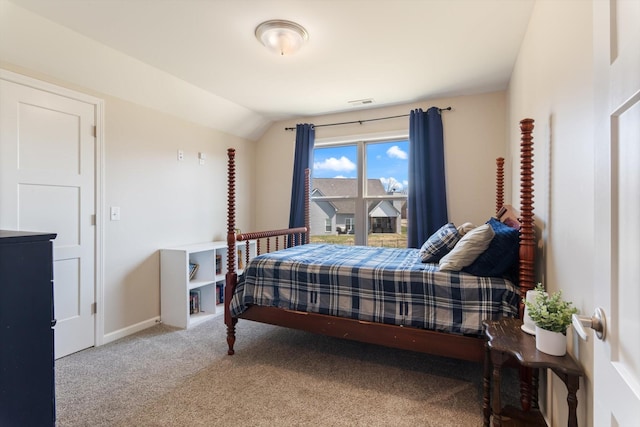 carpeted bedroom featuring visible vents, baseboards, and vaulted ceiling