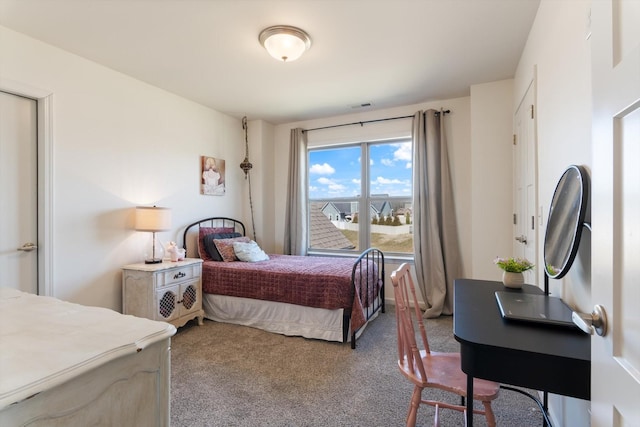 bedroom with visible vents and carpet