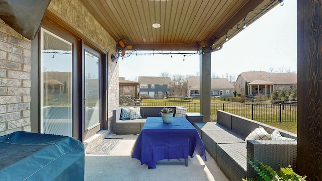 view of patio / terrace featuring a residential view, fence, and an outdoor hangout area