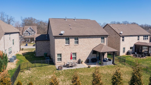 back of house with a fenced backyard, a lawn, a gazebo, and a patio