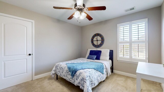 bedroom featuring baseboards, visible vents, carpet floors, and ceiling fan