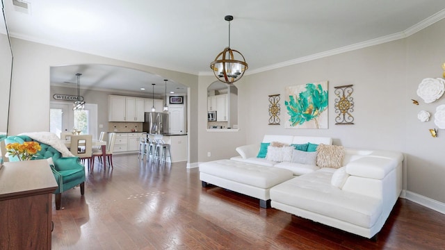 living room with dark wood-type flooring, visible vents, arched walkways, and a chandelier