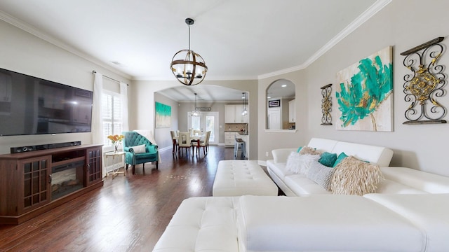 living room with wood finished floors, baseboards, arched walkways, ornamental molding, and a notable chandelier