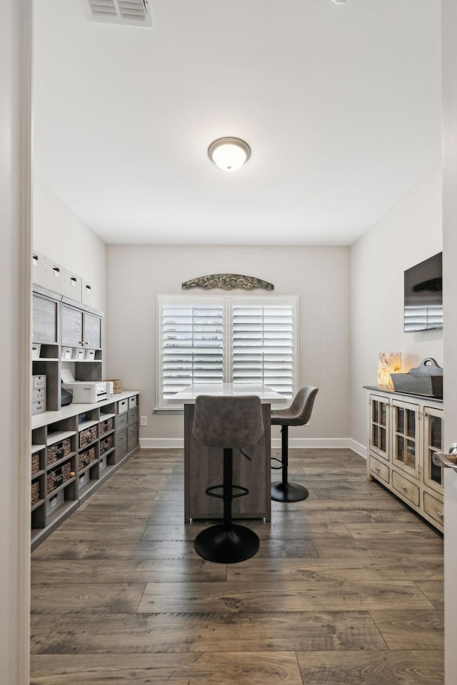 interior space featuring visible vents, baseboards, and dark wood finished floors