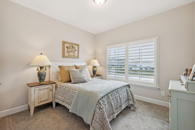 carpeted bedroom featuring baseboards