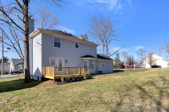 back of house with a wooden deck, a lawn, french doors, and a chimney