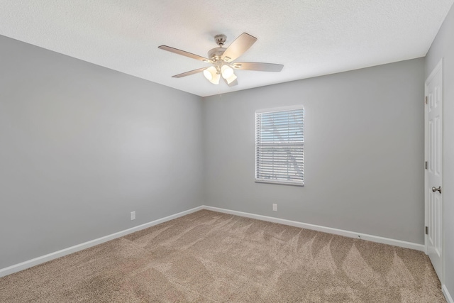 empty room featuring carpet flooring, a ceiling fan, baseboards, and a textured ceiling