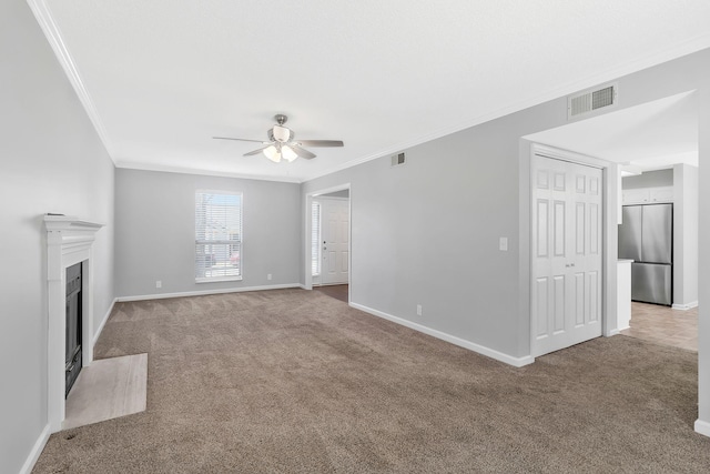 unfurnished living room with visible vents, carpet floors, and a fireplace with flush hearth