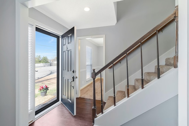 foyer featuring crown molding, stairway, recessed lighting, and wood finished floors