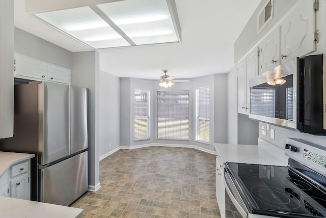 kitchen with stainless steel appliances, visible vents, white cabinets, and light countertops