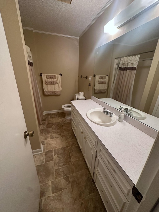 full bath with vanity, a textured ceiling, stone finish flooring, crown molding, and toilet