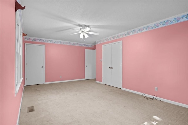 134 N Forrest Ave, Camden, TN 38320 - unfurnished bedroom with carpet, baseboards, a ceiling fan, and a textured ceiling
