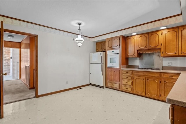 134 N Forrest Ave, Camden, TN 38320 - kitchen featuring white appliances, brown cabinets, light countertops, light flooring, and baseboards
