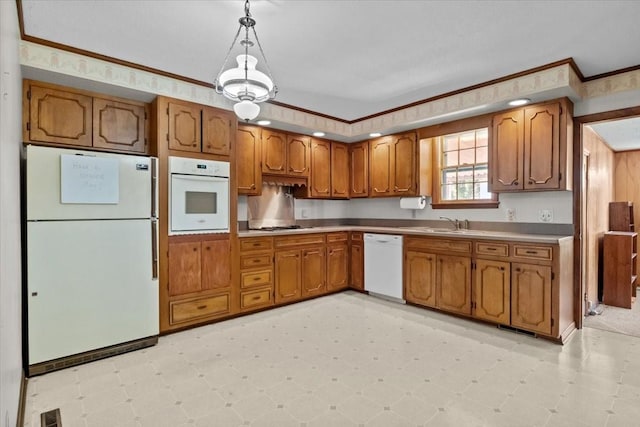 134 N Forrest Ave, Camden, TN 38320 - kitchen with white appliances, brown cabinets, a sink, decorative light fixtures, and light floors