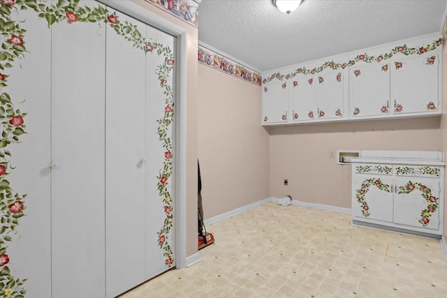 134 N Forrest Ave, Camden, TN 38320 - laundry area featuring cabinet space, electric dryer hookup, hookup for a washing machine, light floors, and a textured ceiling