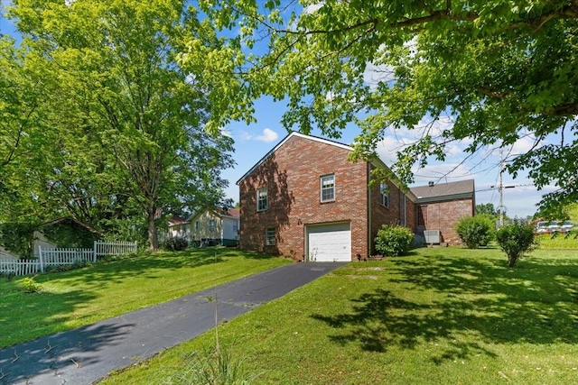 134 N Forrest Ave, Camden, TN 38320 - view of home's exterior featuring a garage, driveway, and brick siding