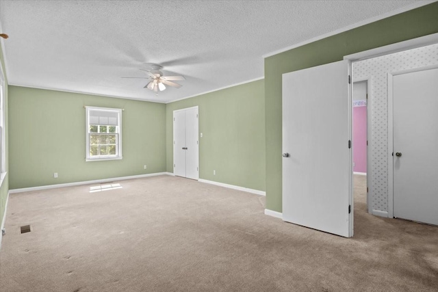 134 N Forrest Ave, Camden, TN 38320 - unfurnished bedroom featuring carpet flooring, a textured ceiling, baseboards, crown molding, and ceiling fan