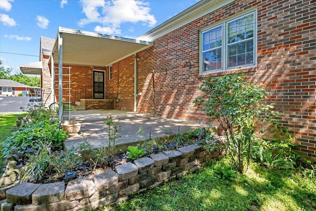 134 N Forrest Ave, Camden, TN 38320 - view of exterior entry featuring brick siding