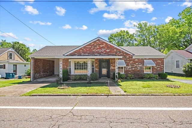 134 N Forrest Ave, Camden, TN 38320 - view of front facade featuring brick siding, concrete driveway, a front lawn, and an attached carport