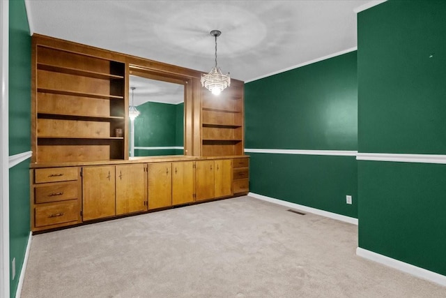 134 N Forrest Ave, Camden, TN 38320 - empty room with light colored carpet, baseboards, built in shelves, and crown molding