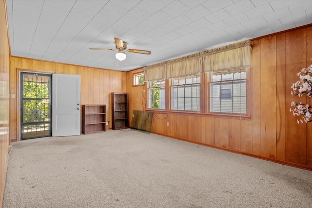 134 N Forrest Ave, Camden, TN 38320 - carpeted spare room with wooden walls and ceiling fan