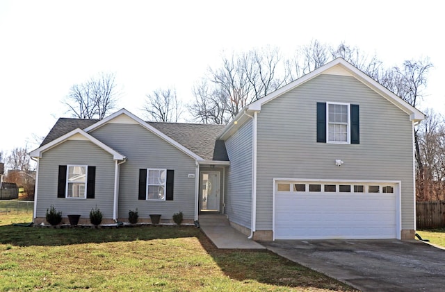 view of front of home featuring a front lawn, concrete driveway, an attached garage, and a shingled roof