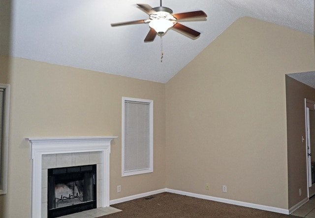 unfurnished living room featuring baseboards, lofted ceiling, carpet flooring, and a tile fireplace